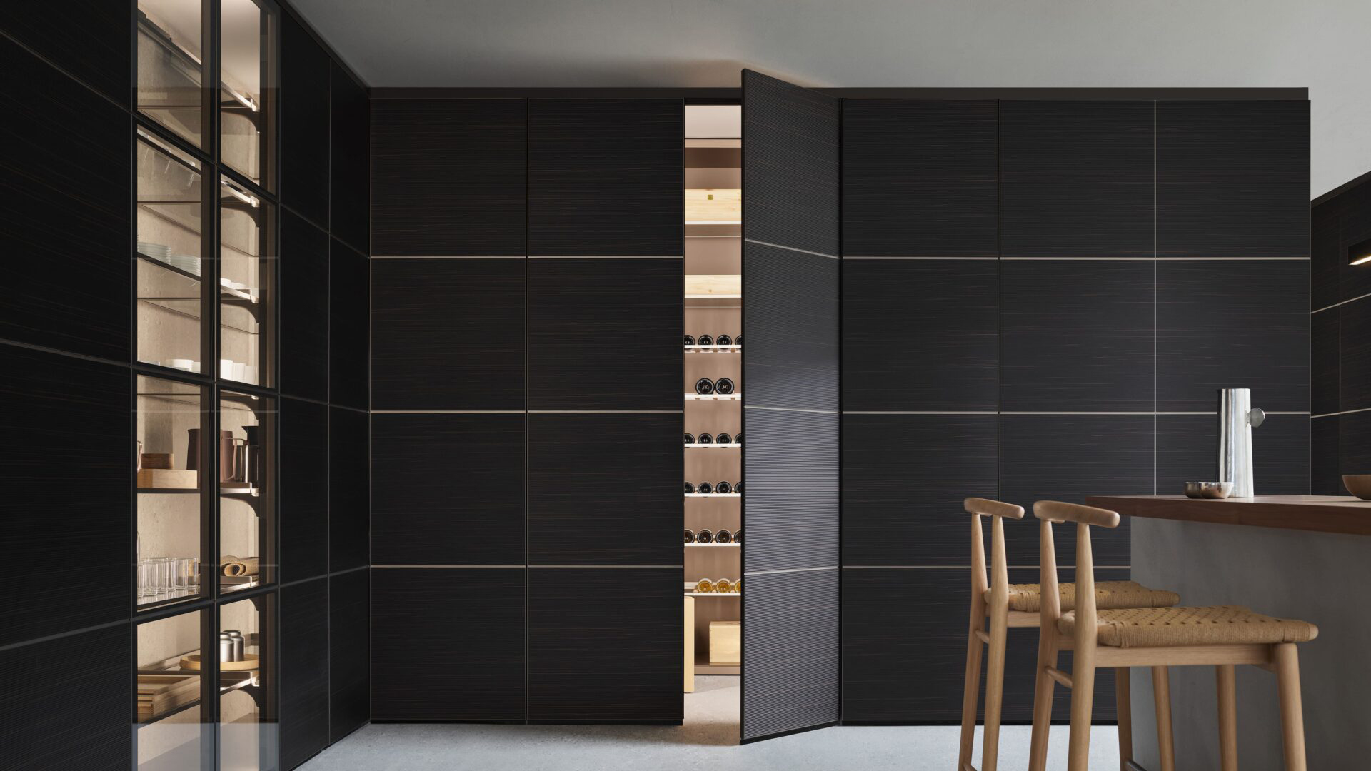 Concealed wine room entrance with coordinated dark wall panels nearly closed