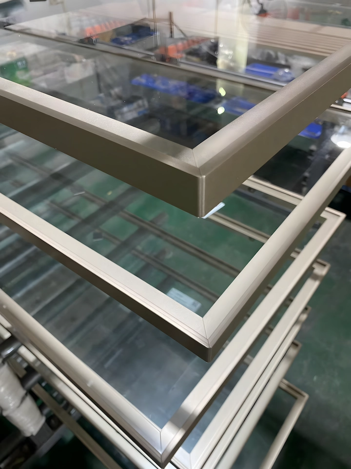 Close-up of an aluminum-framed glass door corner and surface finish in the workshop