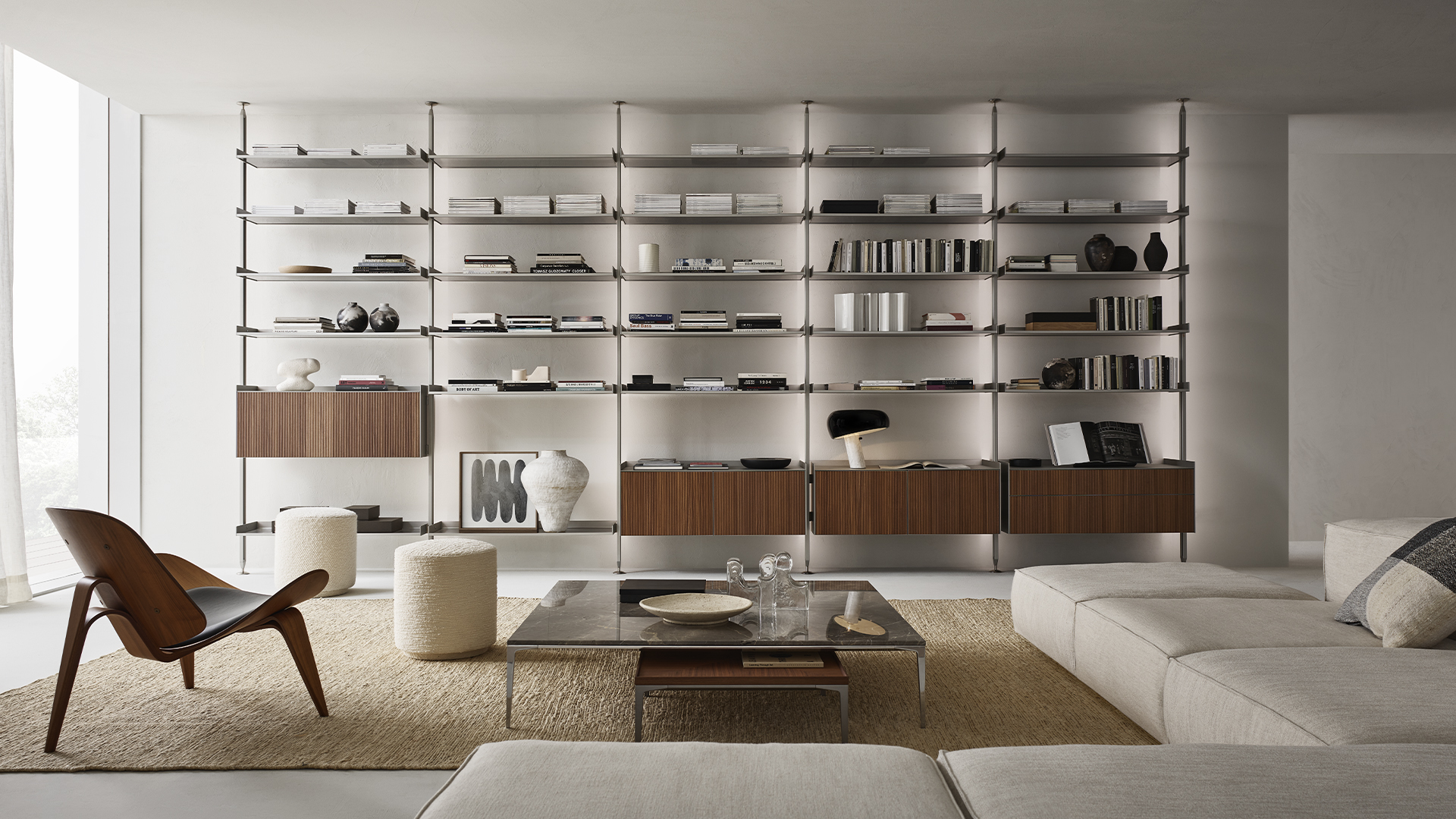 Natural wood modular bookshelf wall in a bright minimalist living room