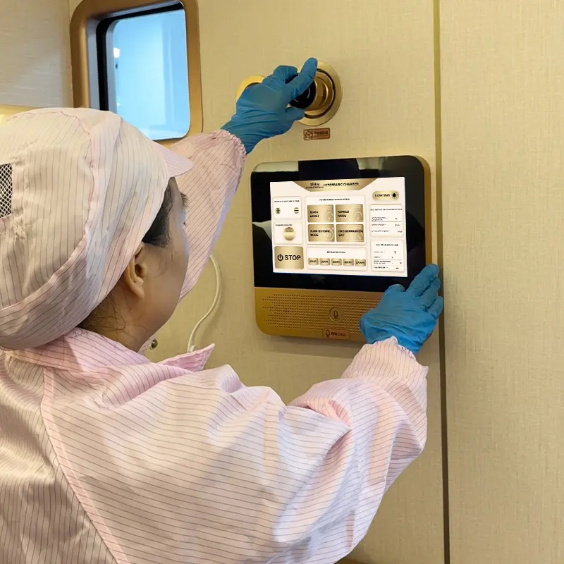 Technician inspecting a Ueerl chamber control panel before shipment