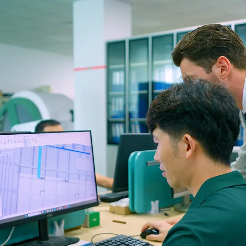 Ueerl engineers reviewing hyperbaric chamber design drawings