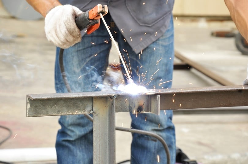 a beginner practicing arc starts and bead control with a basic stick welder setup