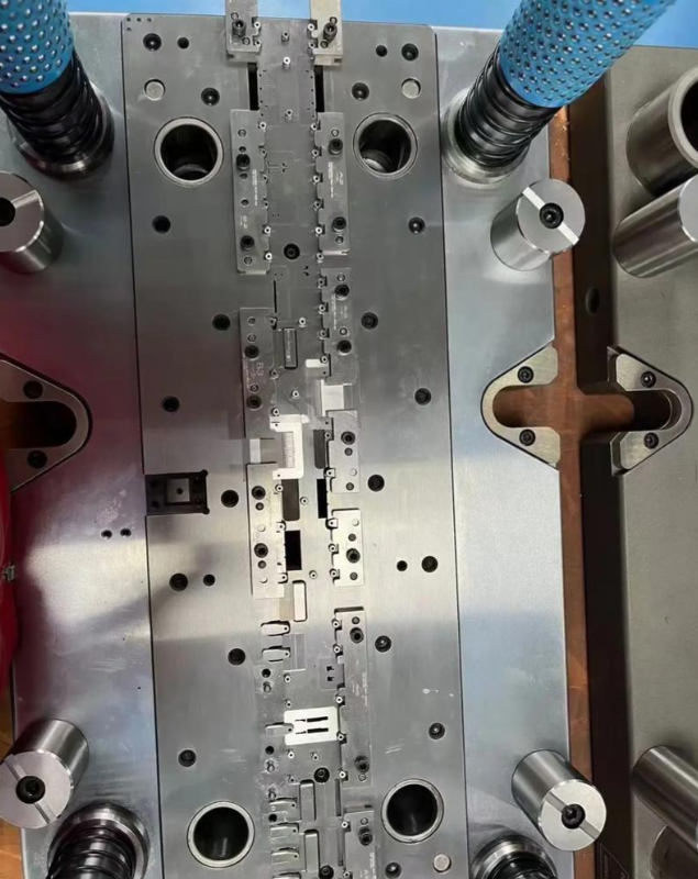 progressive die configuration with multiple stations performing sequential stamping operations on continuous metal strip