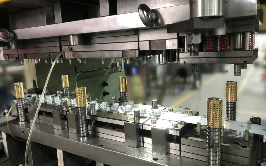 industrial stamping press transforming flat sheet metal into precision formed components