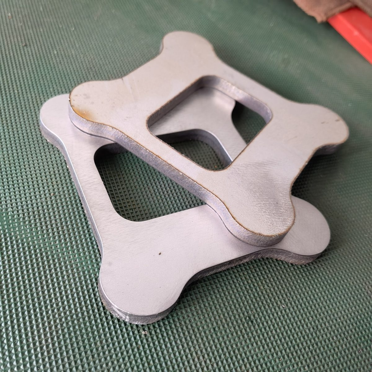 Sheared edge of a stamped bracket showing burr height at the die cutting edge