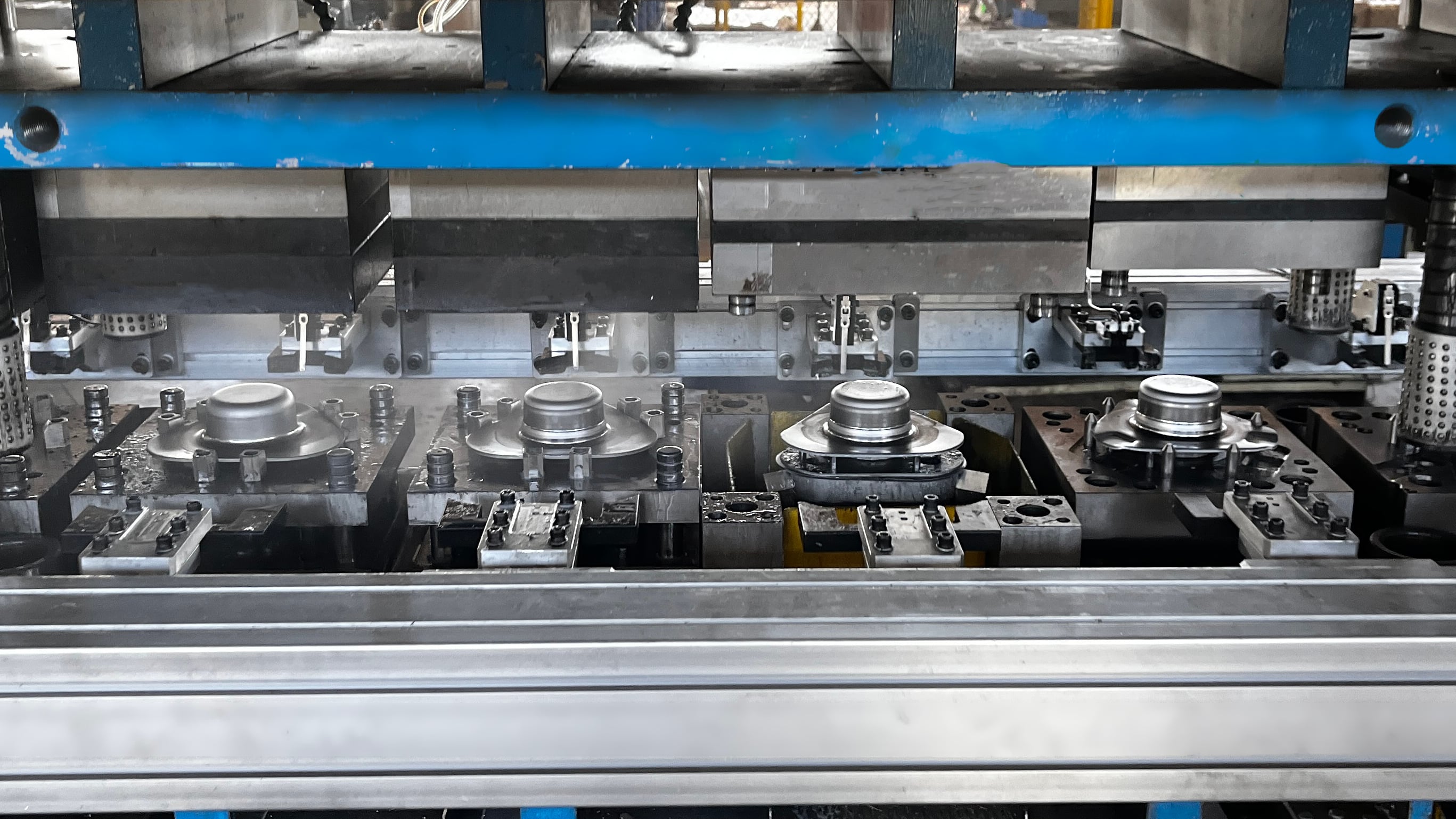 progressive die performing multiple stamping operations in sequence