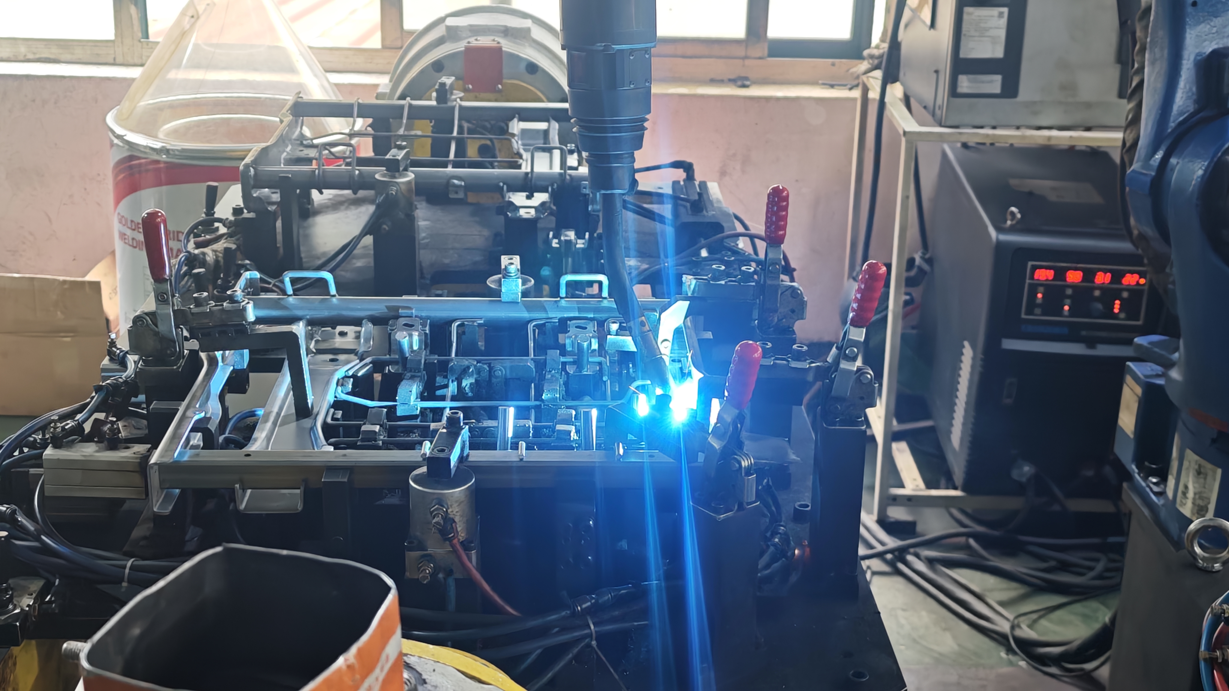 welder joining two aluminum parts with tig and mig equipment nearby