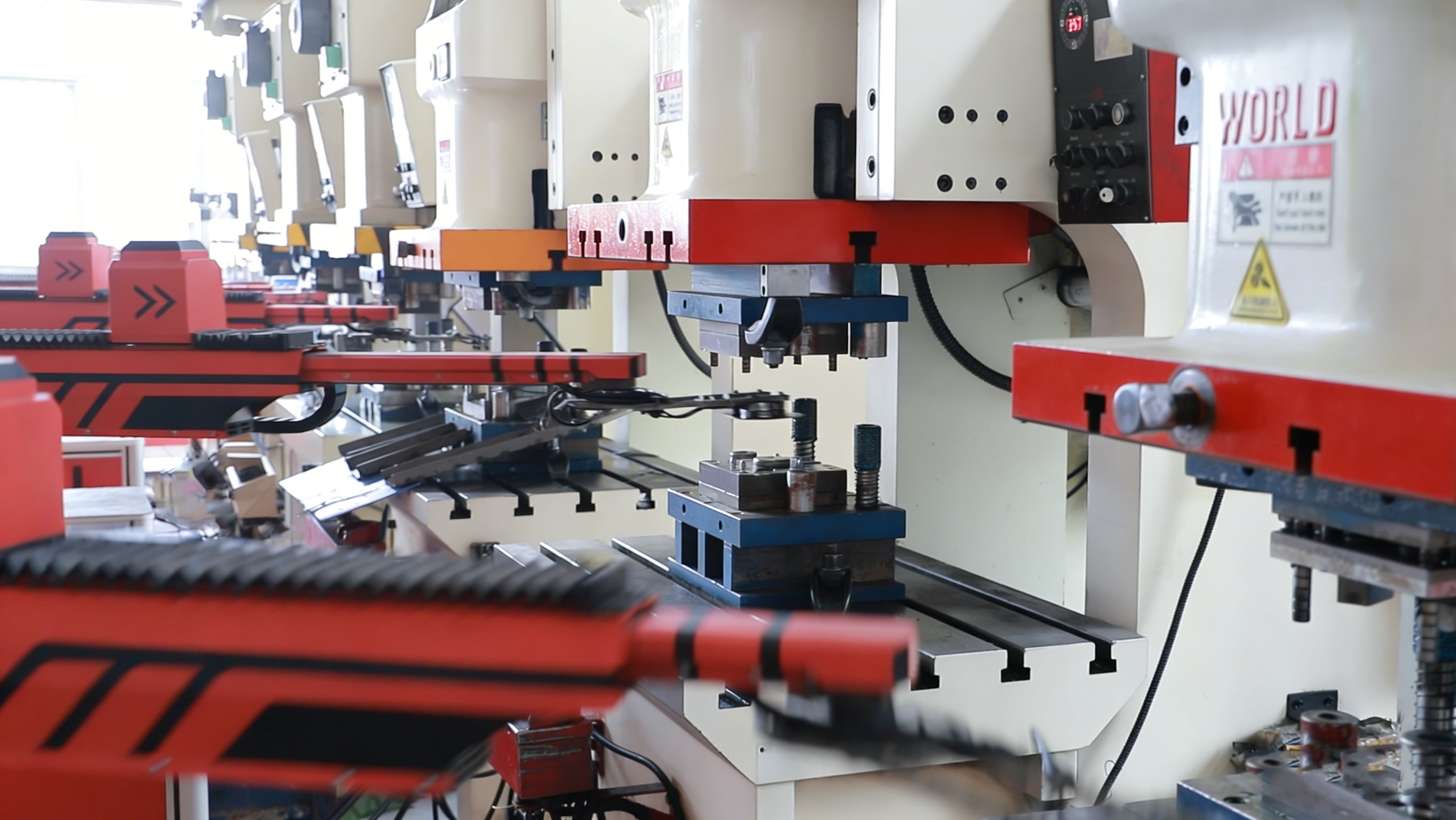 Automotive stamping press line with a progressive die producing steel brackets