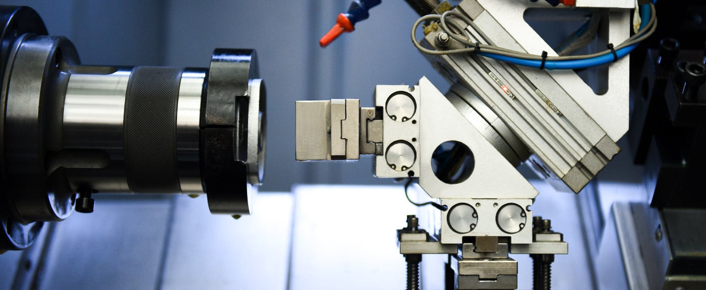 cnc lathe performing external turning operation on cylindrical metal workpiece