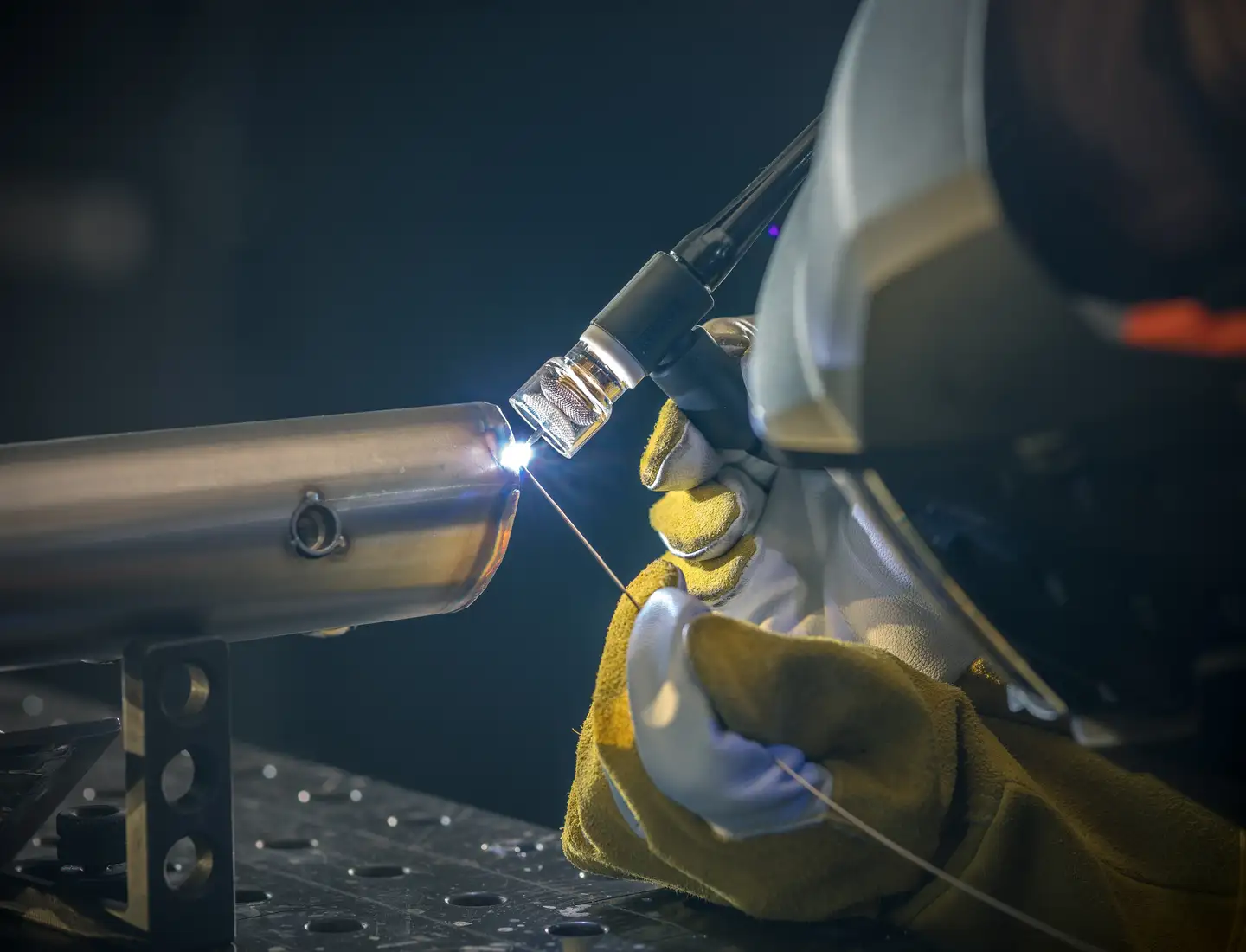 tig welding torch creating a clean weld under shielding gas