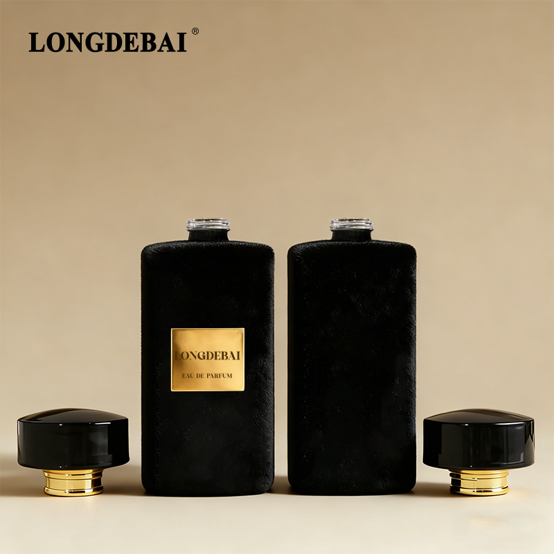 Cylindrical flocked glass perfume bottle with black gold bottle cap details
