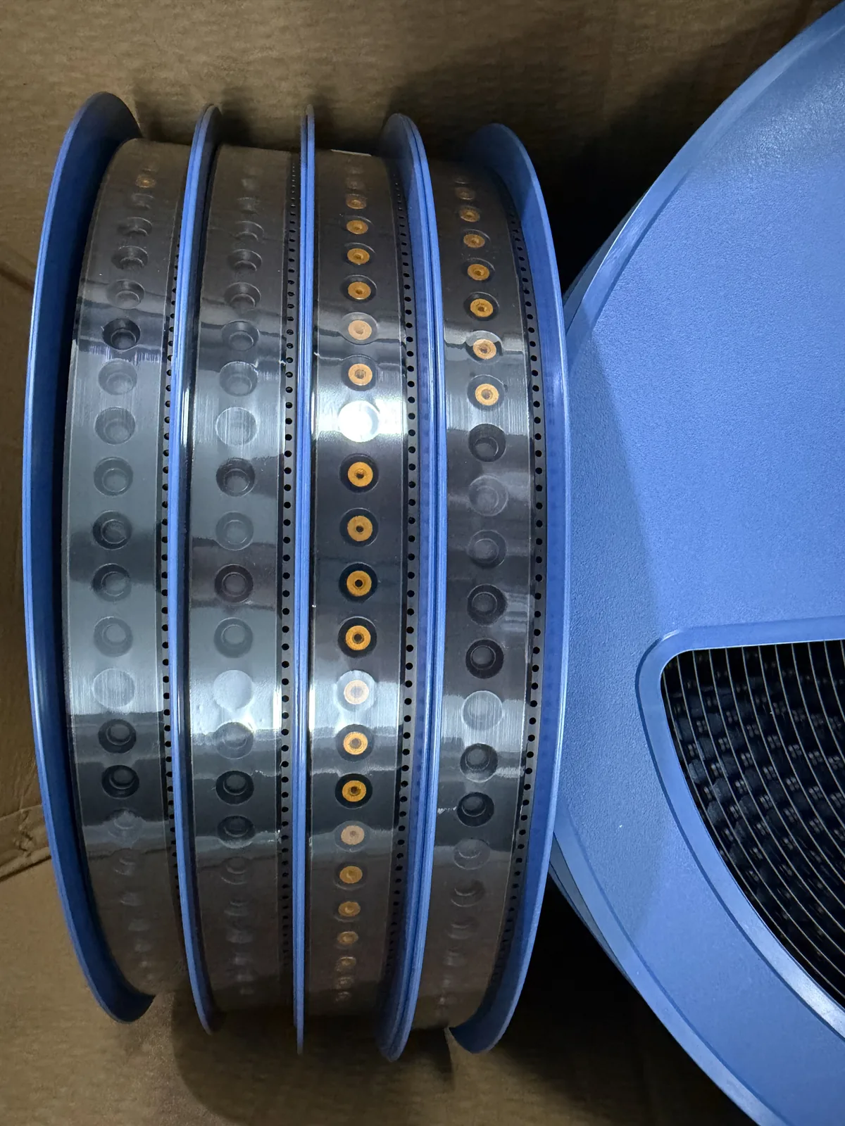 Finished reels of PCB standoffs in tape-and-reel packing