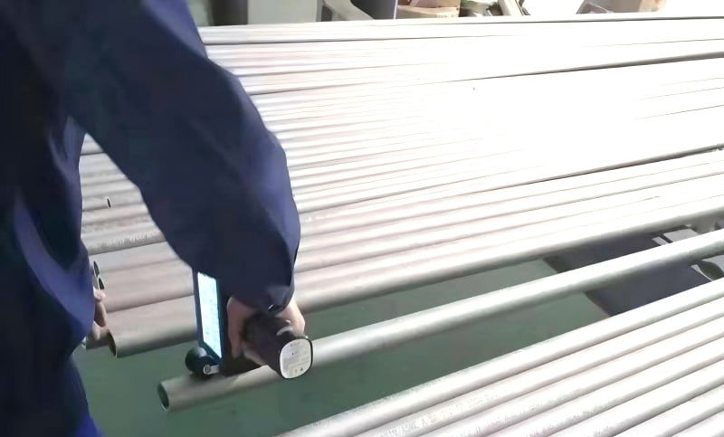 Inspector examining stainless steel flange faces and gasket seats for early crevice attack