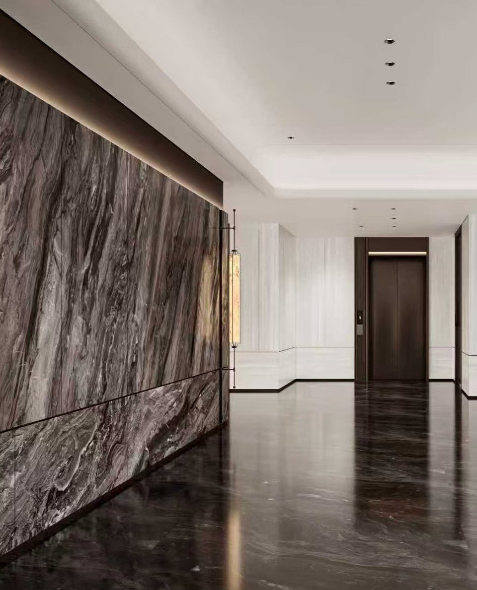 Large-format Arabescato Orobico Grigio marble wall cladding with refined lighting and corridor design.