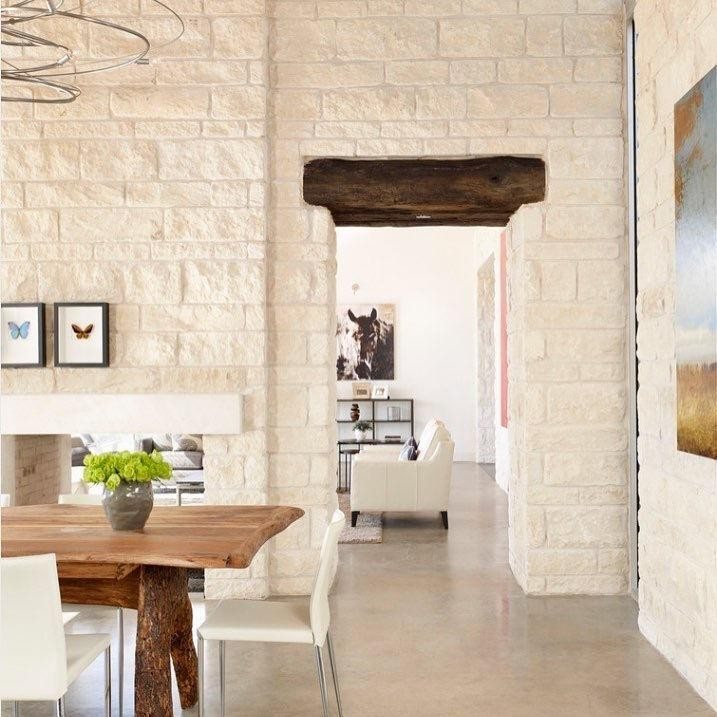Textured Roman Beige Limestone wall cladding in an interior dining space