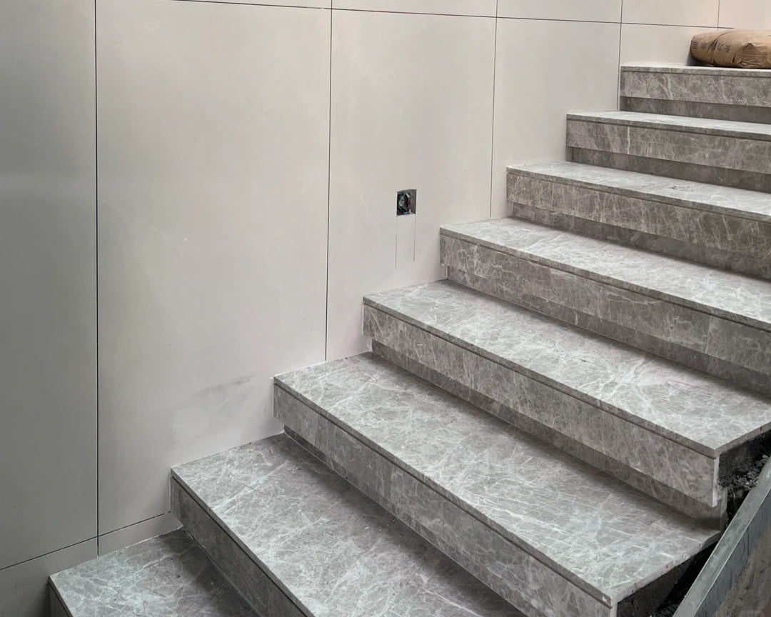 Castle Gray Marble staircase with light grey treads and risers in a modern villa.jpg