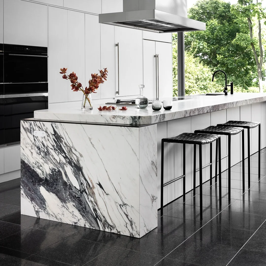 breccia-capraia-marble-waterfall-kitchen-island.webp