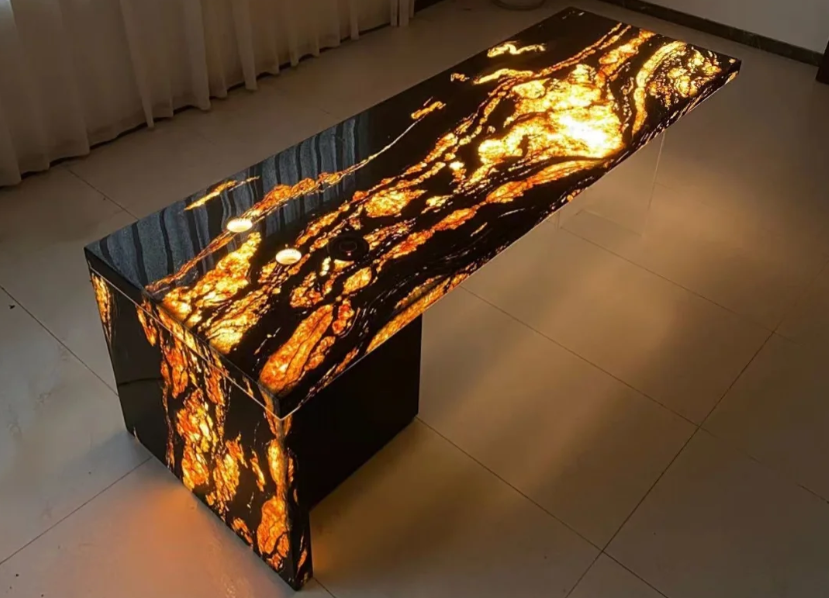 Backlit desk concept in black and gold natural stone