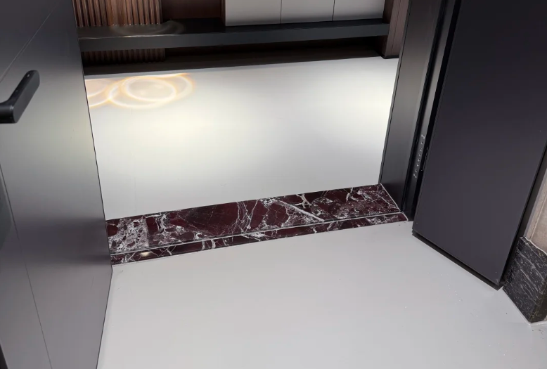 custom marble door threshold between light color floor tiles