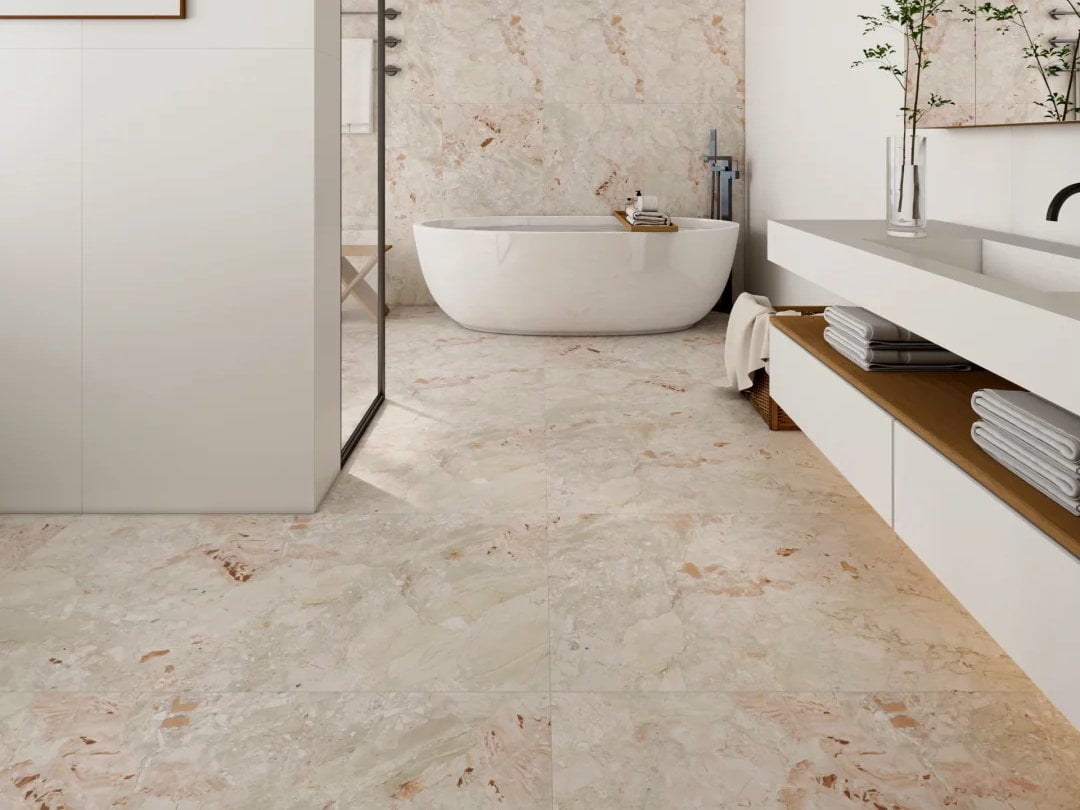 Monet Garden Marble floor in a spa-inspired bathroom with a freestanding bathtub and light cabinetry.