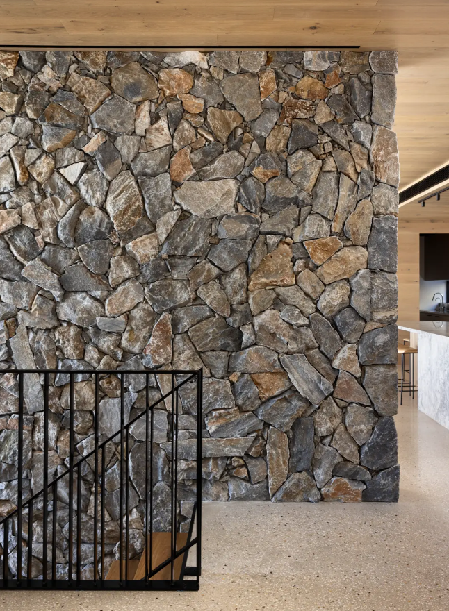 Dark irregular stone cladding in a contemporary interior