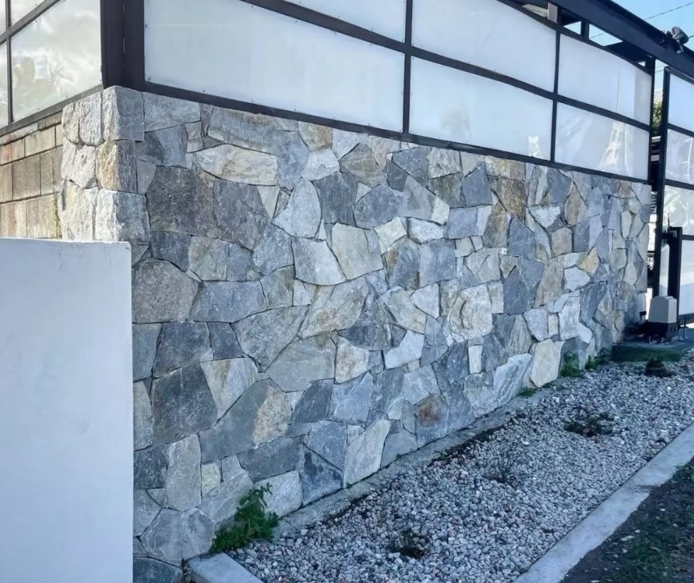 Grey natural stone exterior wall cladding on a contemporary building