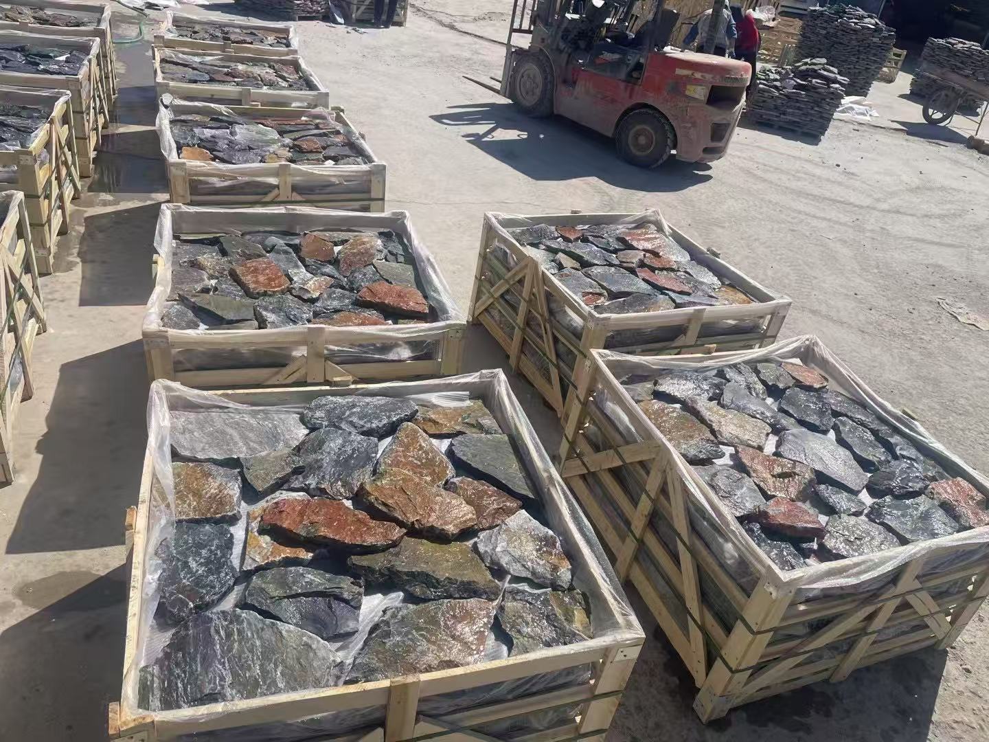 Mixed loose stone pieces packed in wooden crates