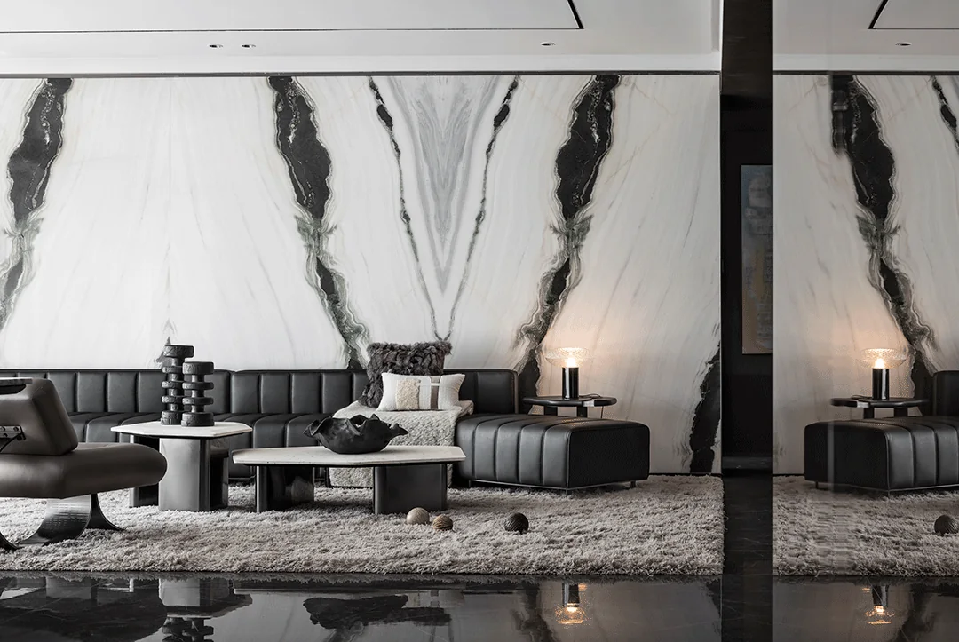 Bookmatched Panda White Marble feature wall in a contemporary living room