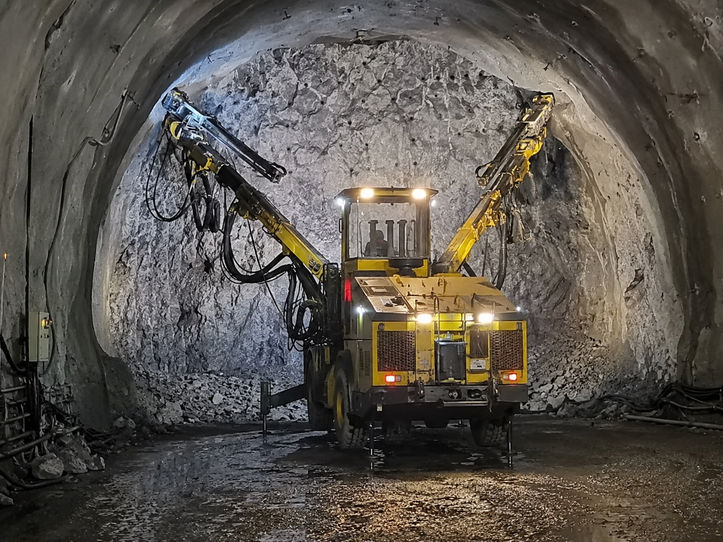 Twin-Boom Underground Development Drill Rig Operating in a Peru Copper Mine.png