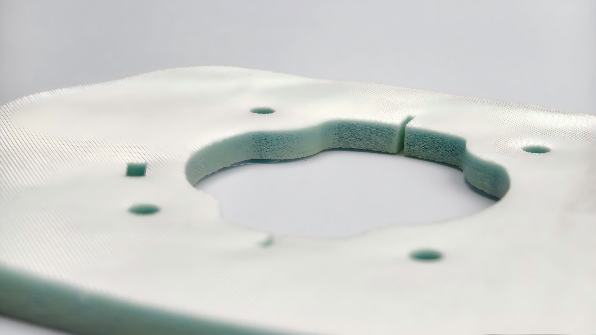 Sealed cut edges on multi-layer synthetic composite materials