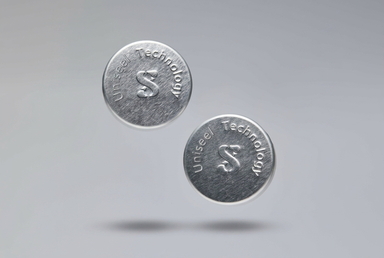 uniseel-technology-premium-silver-tinplate-unishell-caps-with-embossed-logo.png