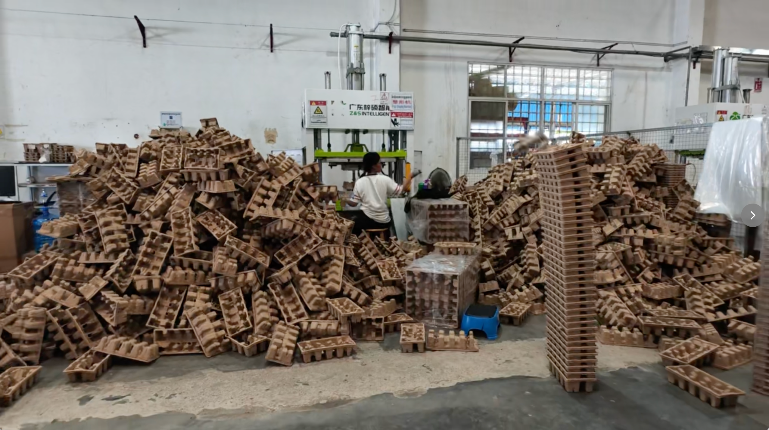 Molded pulp components at a production handling workstation.