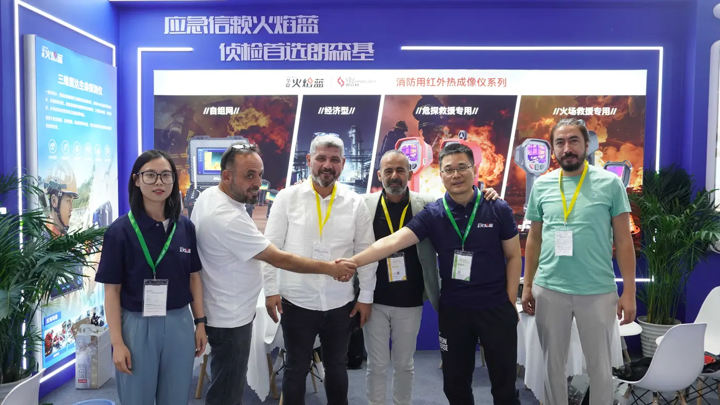 IMG-01 | LSJ Booth E2-39 Handshake International visitors shaking hands with the LSJ team at booth E2-39 of the 21st China International Fire Exhibition in Beijing