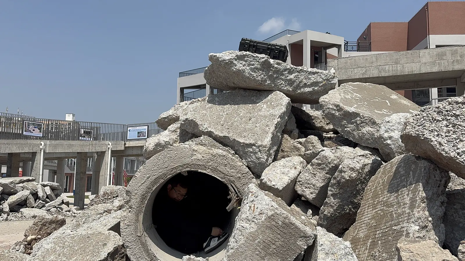LSJ-M radar host placed on top of a concrete rubble pile above a drainage pipe containing a simulated trapped survivor during urban search and rescue training