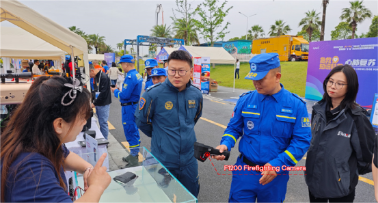 LSJ staff demonstrating a firefighting thermal imaging camera to a Blue Sky Rescue water special search team member at the Mission of Light equipment exhibition