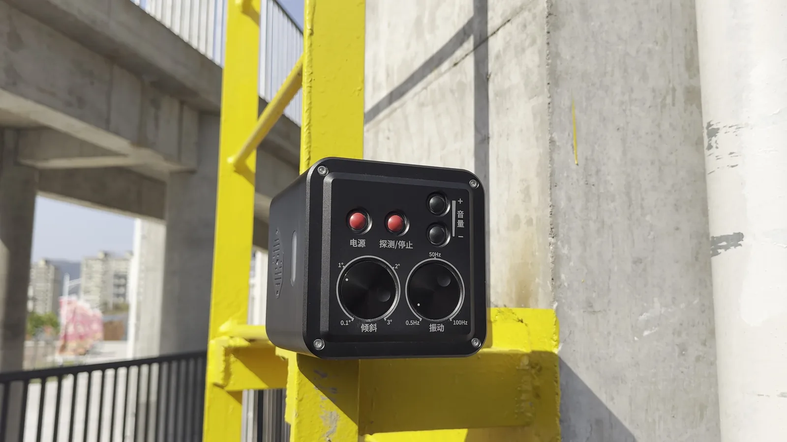 LSJ LS-D01 aftershock alarm magnetically attached to a yellow structural steel I-beam at a rescue training site