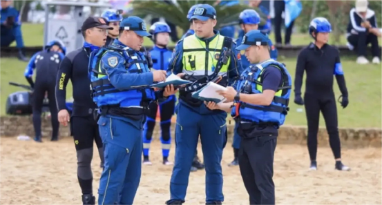 Blue Sky Rescue water rescue team leaders coordinating a briefing on the lakeside beach during the Mission of Light 2025 challenge