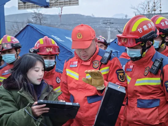 Gansu fire rescue commanders reviewing detector data at an earthquake rescue command post