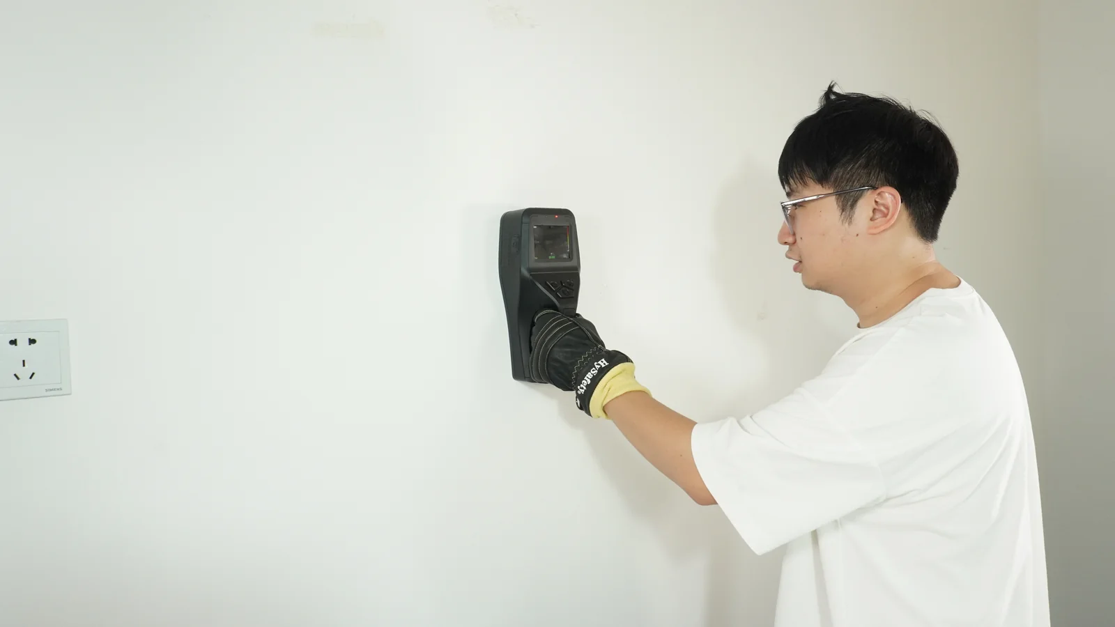 Operator in rescue gloves scanning a wall with the IP66-rated LSJ life detector