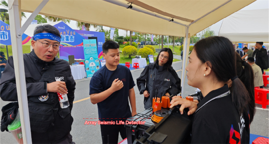 A Blue Sky Rescue officer reviewing LSJ rescue equipment documentation with LSJ staff at the exhibition booth in Changde