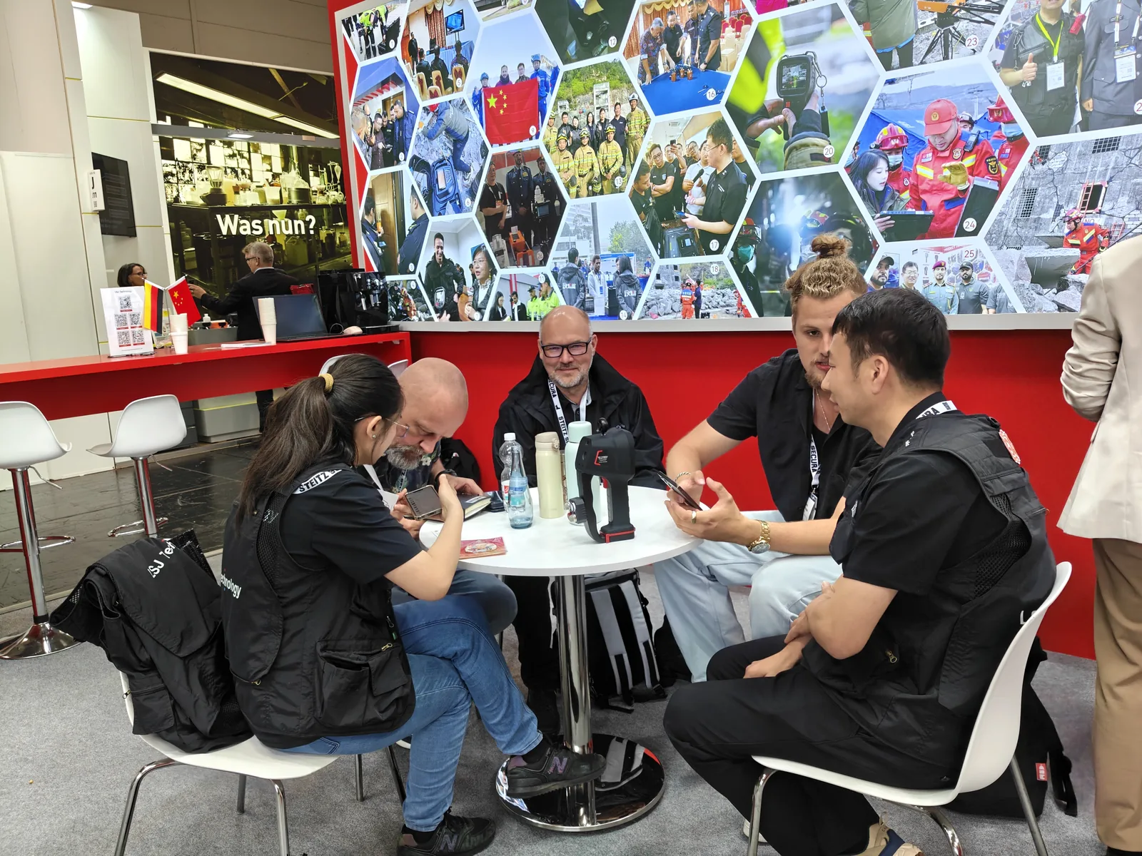 IMG-06 | Distributor Partnership Discussions LSJ staff in detailed partnership discussions with international distributors around a table with an LSJ thermal imaging camera at the Hannover exhibition