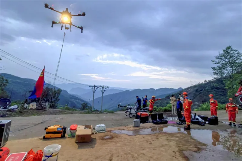 Rescue drone conducting an aerial survey over a flash flood command site at dusk