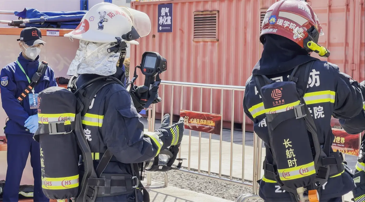 Firefighters equipped with thermal imaging cameras operating at a fire and rescue scene in extreme conditions