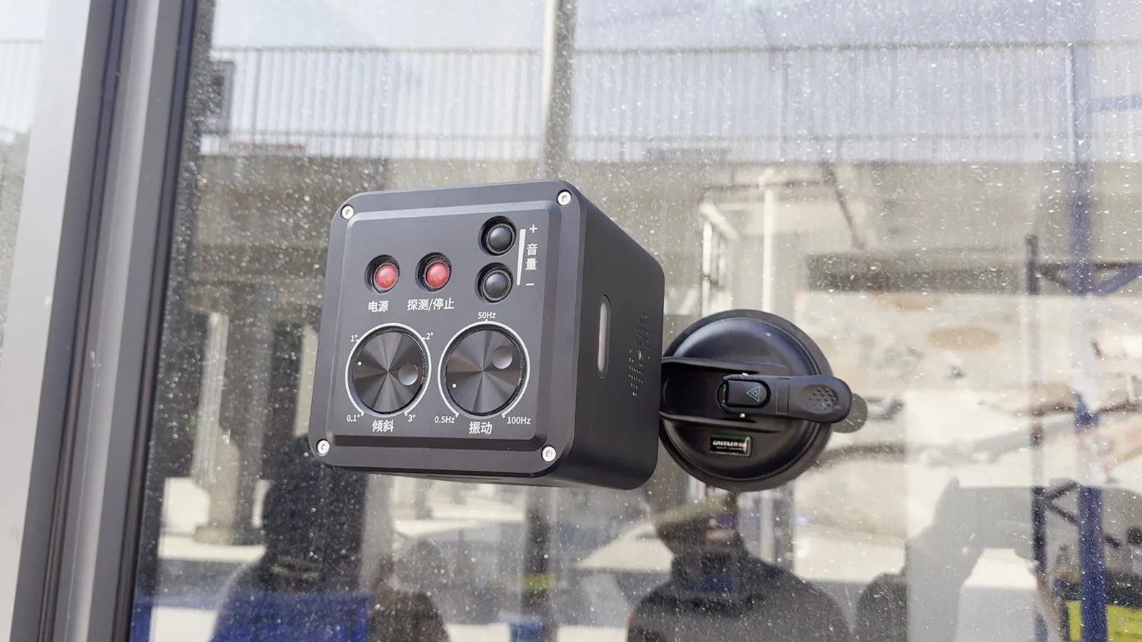 LSJ LS-D01 mounted on a glass wall with the dual suction cup bracket for non-destructive installation