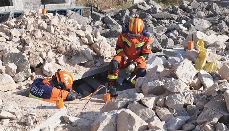 USAR rescuers use an array seismic life detector to search rubble for trapped survivors