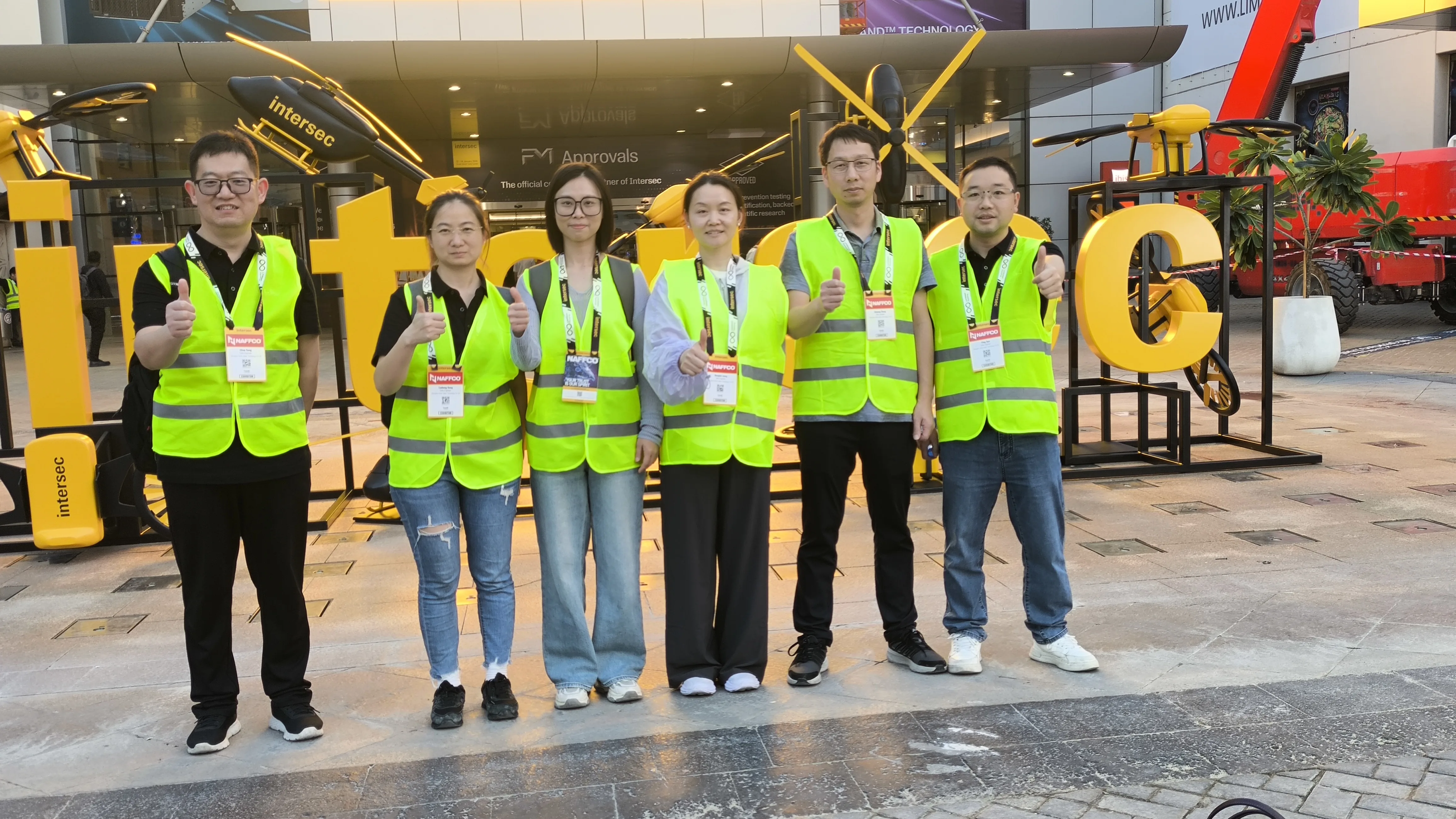 IMG-11 | LSJ Team at INTERSEC 2026 Dubai The LSJ team in high-visibility safety vests posing in front of the giant INTERSEC sign at the Dubai World Trade Centre after the 2026 exhibition.