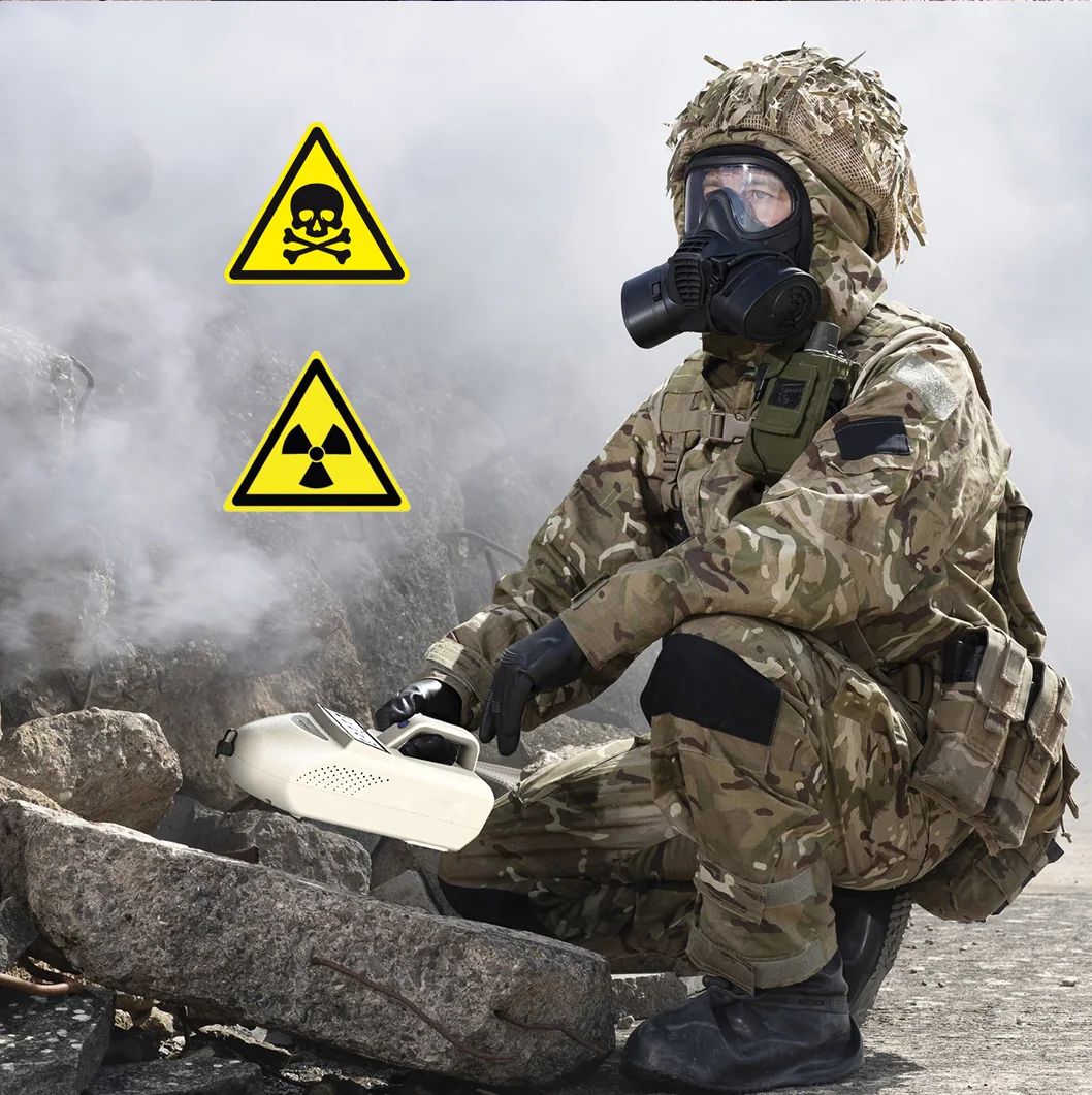 Soldier wearing a gas mask operating the LSJ SEED-PM trace detector for CBRN reconnaissance in a toxic chemical and radiological hazard zone