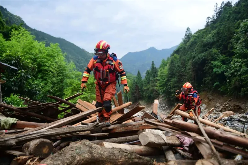 Search and rescue worker crossing debris during a flash flood response operation