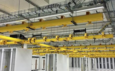 The yellow fiber troughs and wire mesh cable tray used in American data centers