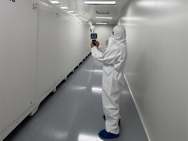 SHP engineer performing particle count validation in cleanroom corridor.jpg